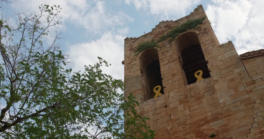 Square Bell Tower With Semicircular Arches Of Sant Pere de Pals Church In Pals, Catalonia, Spain. low angle, 4k