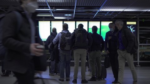 Schiphol , Noord-Holland , Netherlands - 11 05 2021: People Looking At Timetable Monitor Inside Schiphol Airport Terminal