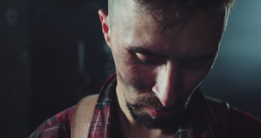 The blacksmith looks at the camera. Close-up shot of a blacksmith