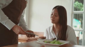 Beautiful customer young woman paying by smartphone in restaurant. asian girl paying by phone in cafe. Contactless payment by mobile phone in inn, cashless technology and money transfer concept - Powered by Shutterstock - Get 15% off with code: PIKWIZARD15