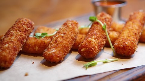 Stock food video of mozzarella cheese sticks cooked for dinner in restaurant. Gourmet appetizer dish for wine party