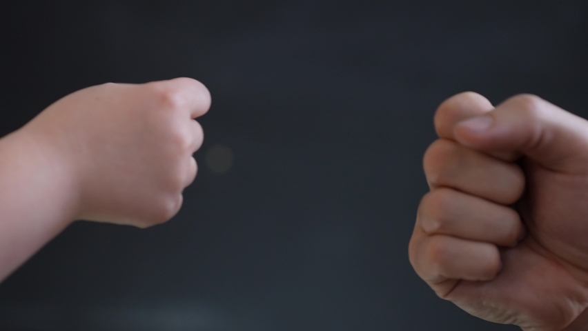 Father son fists together. Two fists together symbol of teamwork. Punching friendly greeting. Successful teamwork.Business contract greeting.Father and son fists together teamwork.Victory in business. Royalty-Free Stock Footage #1082478076
