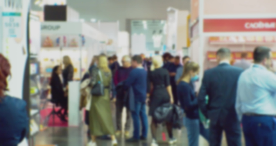 abstract business background. Blurred silhouettes of unrecognizable people in a large bright hall.