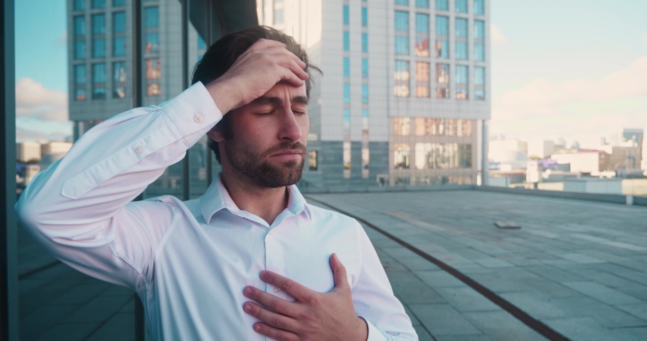 Trouble breathing, chest pain. Close-up of standing bearded man, he has difficulty breathing or chest pain, touches his chest with hand. Heart attack, thoracic osteochondrosis, panic attack concept. | Shutterstock HD Video #1082481856