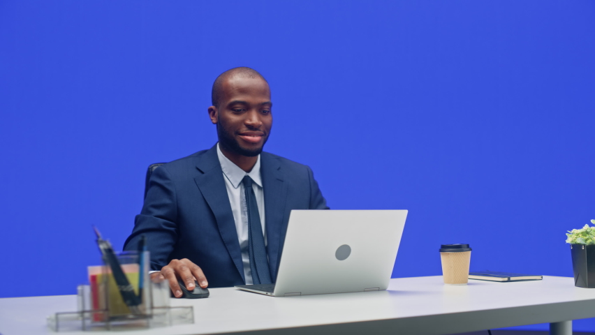 Green Screen Office Background: Black Businessman Sitting at His Desk Working on a Laptop Computer. African American Man working with Data e-Commerce Analysis. 360 Degree Tracking Shot. Moving Around | Shutterstock HD Video #1082482039