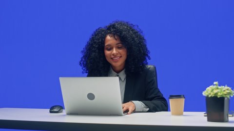 Green Screen Office Background: Black Businesswoman Sitting at Her Desk Working on a Laptop Computer. African American Woman working with Big Data e-Commerce. 360 Degree Tracking Shot. Moving Around