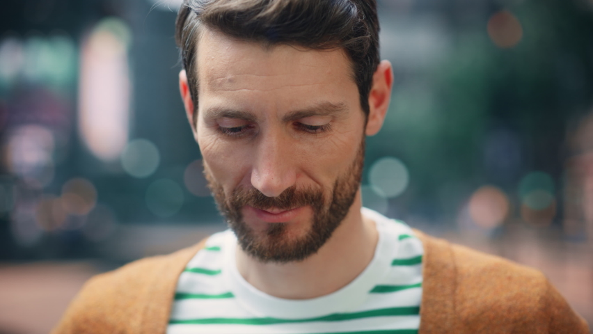 Portrait of a Happy Handsome Bearded Man in Casual Clothes Standing on the Street Looking at Camera, Smiling. Stylish Young Adult or Early Middle Aged Male with Beard. Background Bokeh Big City | Shutterstock HD Video #1082482162
