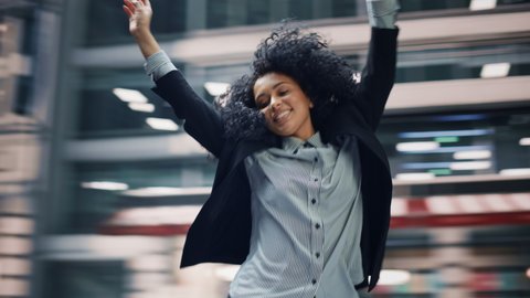 360 Degree Street Shot: Cheerful and Happy Young Black Woman Dancing on the Street. African American Girl with Stylish Afro Hair Having Fun, Joyfully Expressing Herself. Tracking Moving Around Shot