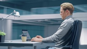 360 Degree Time-Lapse Office: Productive Businessman Sitting at His Desk Working on a Laptop Computer. Man working with Big Data e-Commerce Analysis. Energetic Fast Tracking Shot. Camera Moving Around - Powered by Shutterstock - Get 15% off with code: PIKWIZARD15