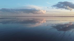 relaxing and peaceful aerial video over the sea showing reflections of cloud formations in the water. meditation view shot