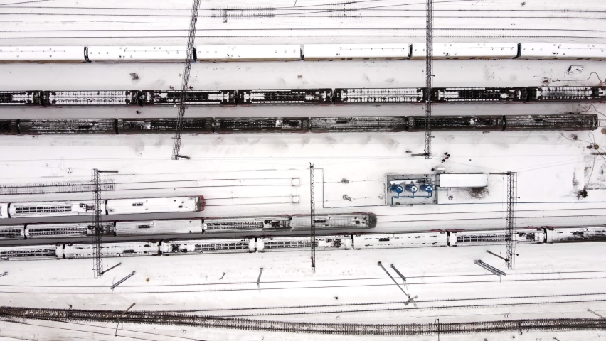 The snow-covered train stops at the station.