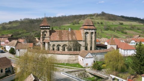 Aerial footage of a Transylvanian fortified church at Valea Viilor, in Sibiu county, Romania. Video shot from a drone while picking altitude. Fortified church from Biertan assembly.