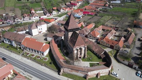 Aerial footage of a Transylvanian fortified church at Axente Sever, in Sibiu county, Romania. Video shot from a drone while circle around the fort.