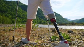 disabled man is using modern prosthetic leg for living a full life and travelling, closeup view of his feet during hiking in nature in summer - Powered by Shutterstock - Get 15% off with code: PIKWIZARD15