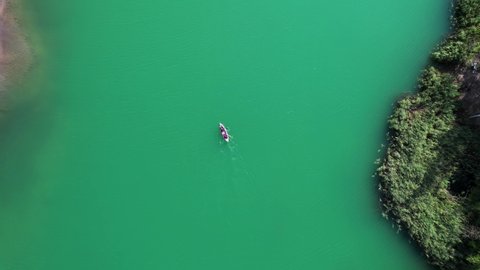 Aerial footage of a kayak on a green river in Konduki Tula, Russia