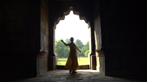 Silhouette of Indian girl performing classical dance, India