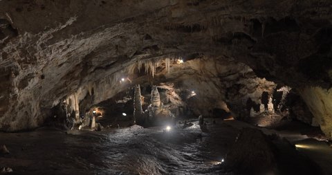 Beautiful shots of karst cave, Lipa Cave situated Serbia, East Europe. Illuminated dark cave with stalactites and stalagmites. Unique nature landscape. High quality 4k footage