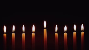 Hanukkah candles. Traditional candelabrum with burning candles on black background. Celebrating a religious Jewish holiday. - Powered by Shutterstock - Get 15% off with code: PIKWIZARD15