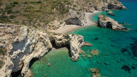 Aerial drone video of small tropical Mediterranean island bay with beautiful turquoise and sapphire clear rocky seascape