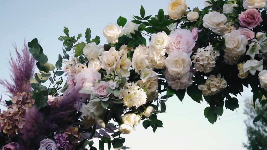Fresh flowers in the wedding arch in the fresh air. Close-up shooting
