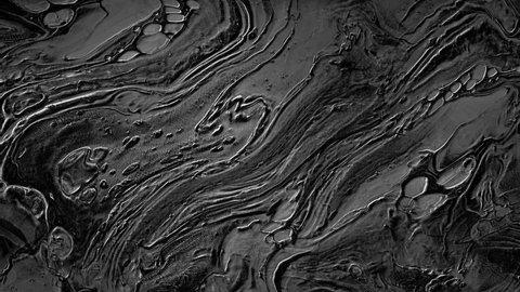 Abstract texture of black plastic metallic fluid in slow motion