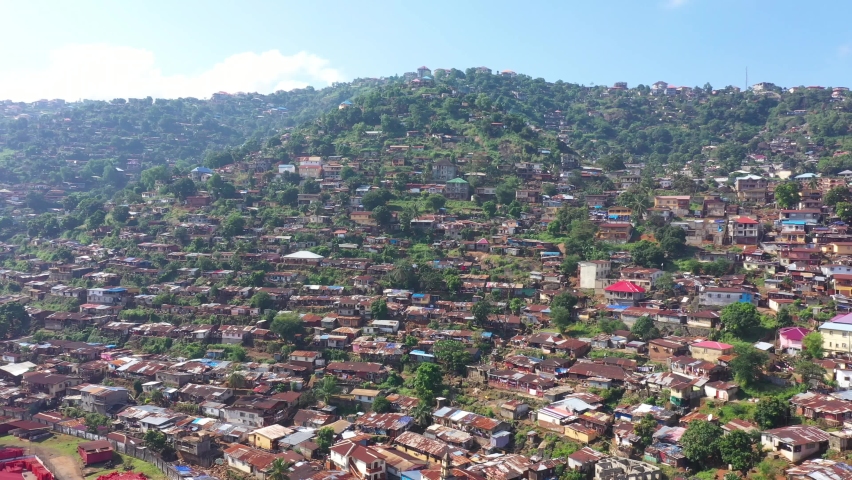 Aerial Freetown Sierra Leone neighborhood mountain no roads. Coast of west Africa suffers extreme poverty and hunger.  Congested crowded homes and businesses. Tropical climate.