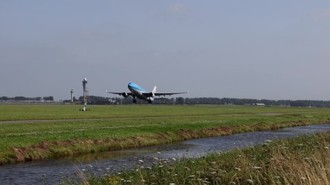 Schiphol, Amsterdam Netherlands - nov 18 2021: Super slow motion delayed 8 times of a KLM Airbus A330-200 taking off on the Polderbaan at Schiphol Airport with the control towers in the background.
