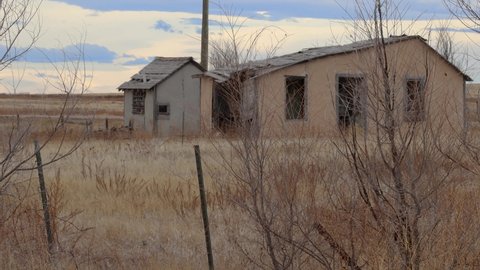 Abandoned farm house on the plains of eastern Colorado. Haunted looking deteriorated home and shed. New Raymer 2021.