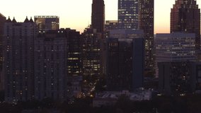 Aerial footage of Midtown Atlanta at sunset.  The camera revolves around a side street.  