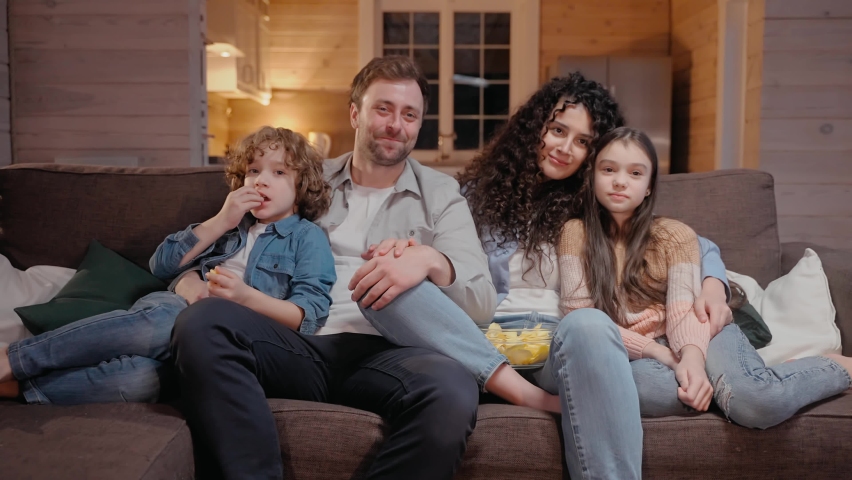 Family watching a movie together at home hugging and laughing with comedy. Family spends time together in lockdown. 50fps. High quality 4k footage Royalty-Free Stock Footage #1082562178