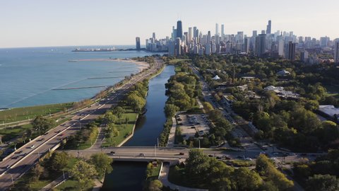 Aerial above expressway and city park by Lake Michigan with Chicago downtown skyline