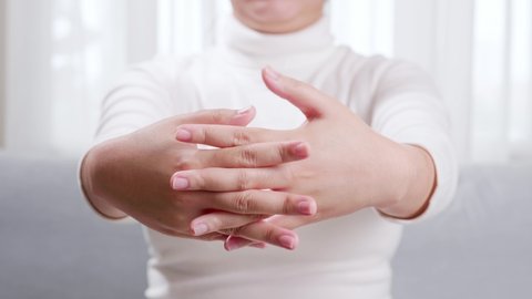 Close up of woman doing hand massage and stretching for soothing and relaxing. Concept of self hand massage.