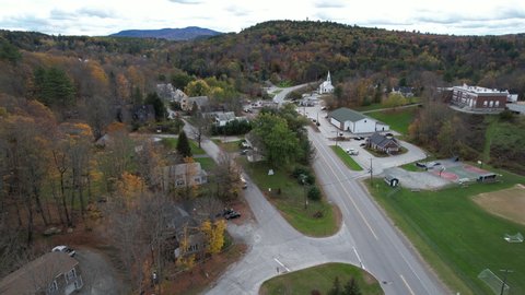 Sunapee Town, New Hampshire, USA. Drone Aerial View of Colorful Autumn Foliage, Houses and United Methodist Community Church