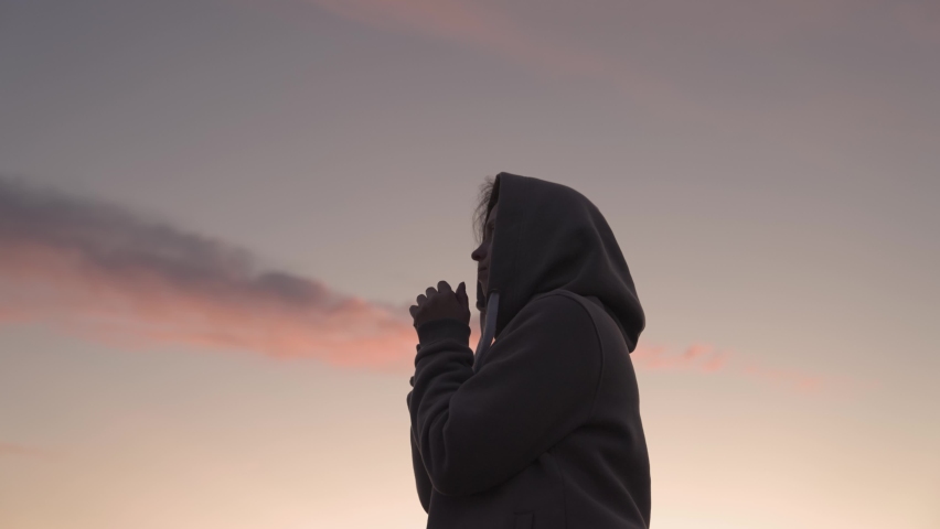 Girl praying on a pink sky background, believe in good good, ask for help, dream looking up, motivation inspiration outdoors, woman thinks meditating, wanderlust concept, heavenly light Royalty-Free Stock Footage #1082577307