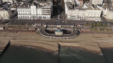 Eastbourne Bandstand on the Seafront of Grand Parade with Devonshire Place leading away behind the Bandstand. Aerial Footage.