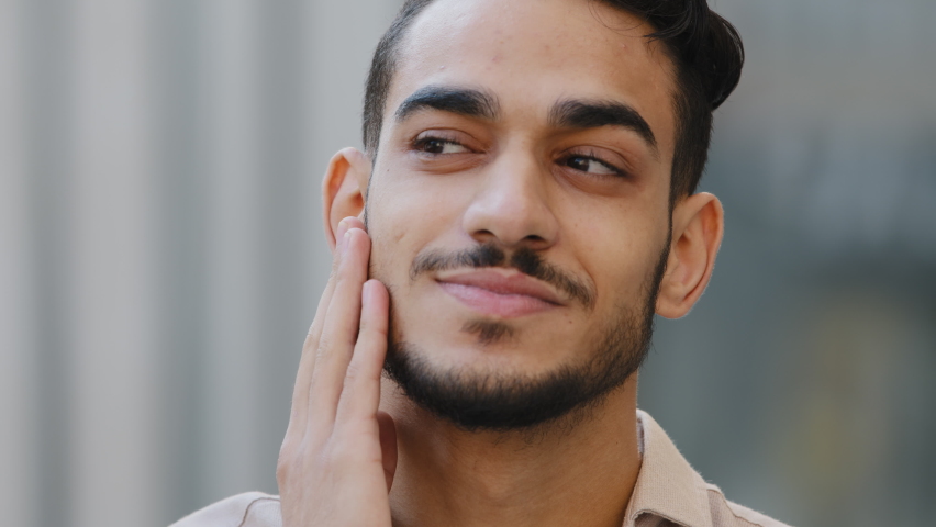 Extreme close-up male portrait outdoors face of bearded hispanic arabic guy brunette man client of barbershop satisfied happiness smiling touching chin beard enjoying haircut after shaving service Royalty-Free Stock Footage #1082589481