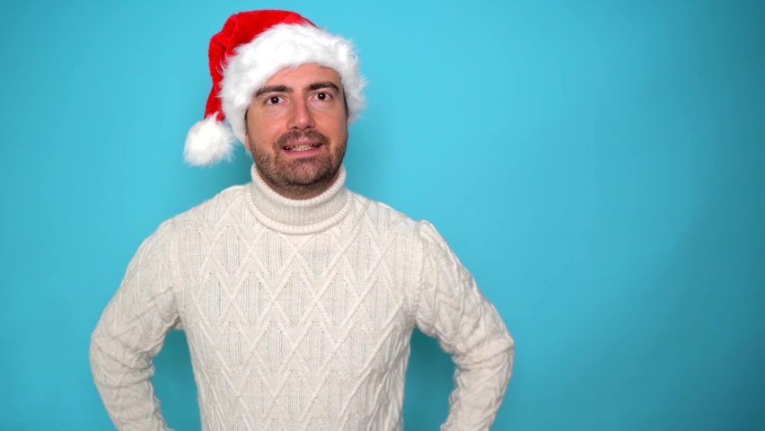 This video is about happy man wearing santa claus hat on blue background