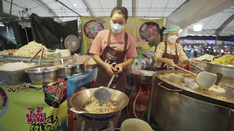 Phuket Thailand-November 18,2021: The best street food Pad thai favorite and famous Asian. Chef cooking Pad Thai noodles food night market. 