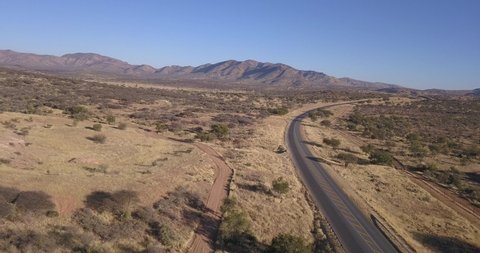 Khomas Hochland, B1 highway, Namibia, 27.06.20: 4K aerial drone video of African savanna hills, large red granite boulders range near highway south of Windhoek in central highland of Namibia, southern