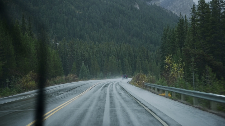 Road trip on highway in rainy and gloomy day at national park