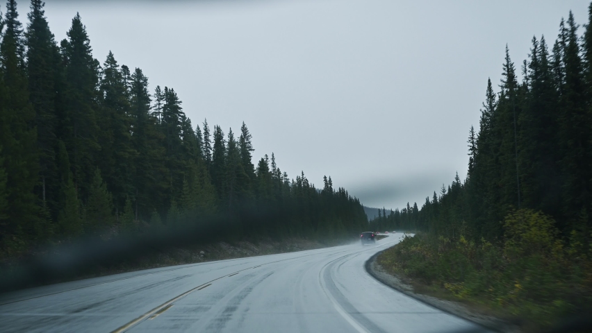 Road trip on highway in rainy and gloomy day at national park