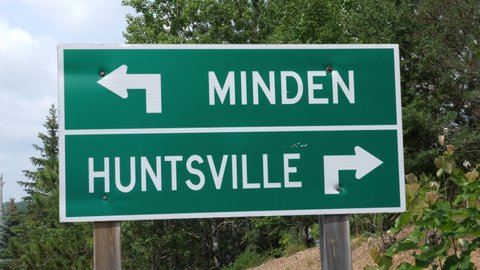 Tilt down to Minden and Huntsville road sign. Minden, Ontario, Canada.