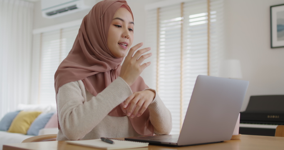 Asia arab people young woman wear hijab headscarf plan study MBA college class note idea data in sale report remote work at home on laptop. Happy advisor lifestyle smile cowork smart workforce job. Royalty-Free Stock Footage #1082601889