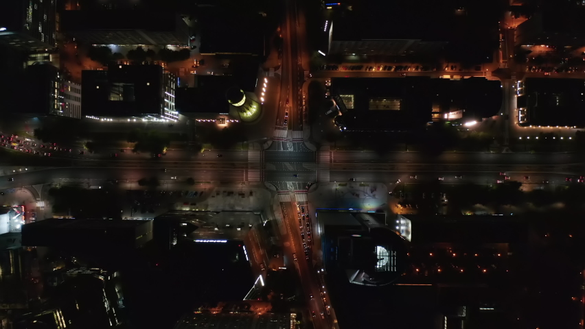 Aerial birds eye overhead top down view of streets and illuminated buildings in night city. Warsaw, Poland Royalty-Free Stock Footage #1082602849