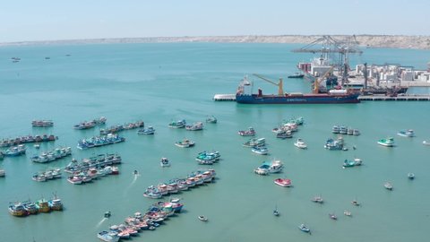 Paita, Piura - Peru, June 15 2021: Paita port aerial view of fishing ships and a huge ship at the port"
