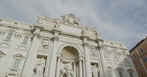 Tilting up shot: Trevi fountain in the morning kissed by daylight in Rome, Italy. Slow motion 50fps 4k