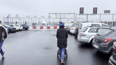Vendenheim, France - Circa 2021: Woman with stroller and kids on skates walking to open toll road gates during launch day of the Contournement Ouest de Strasbourg A 355 highway