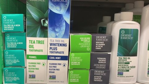 Edmonton, Canada - November 9, 2021: Desert Essence natural toothpaste and mouthwash on display on a grocery store shelf