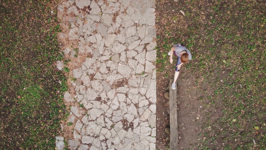 Aerial view of a female while training in the park.	
