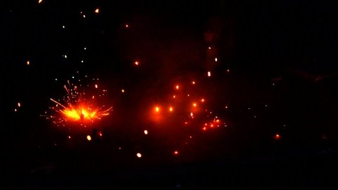 Super slow motion video, Spark shower fireworks or firecrackers in home driveway at night. Sparkling firecrackers on diwali celebration